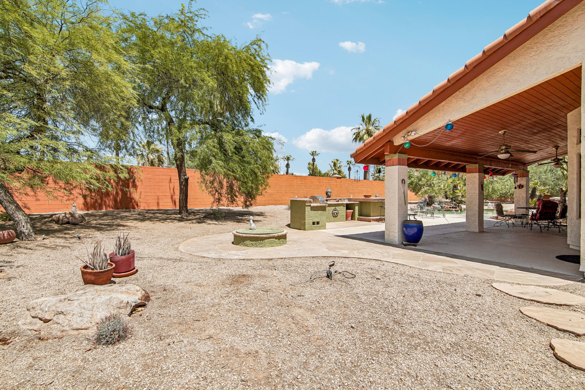 Wide yard, covered patio and mature desert landscaping